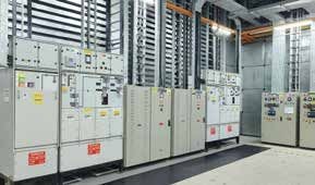 Rows of electrical switchgear cabinets inside a data-centre power room